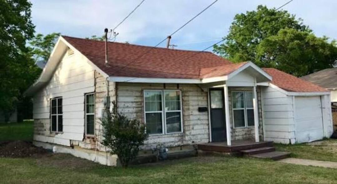 Small house with peeling paint before repaint